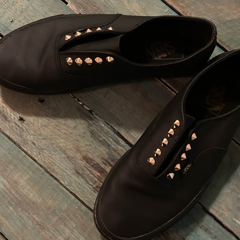 Vans black studded slip on shoes.